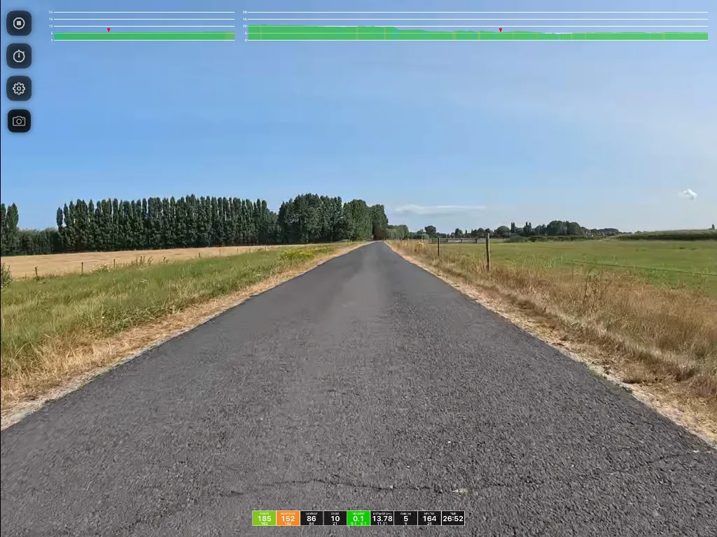 Straight asphalt road stretching through flat rural farmland with poplar trees lining the left side, green fields on both sides, and clear sky above.