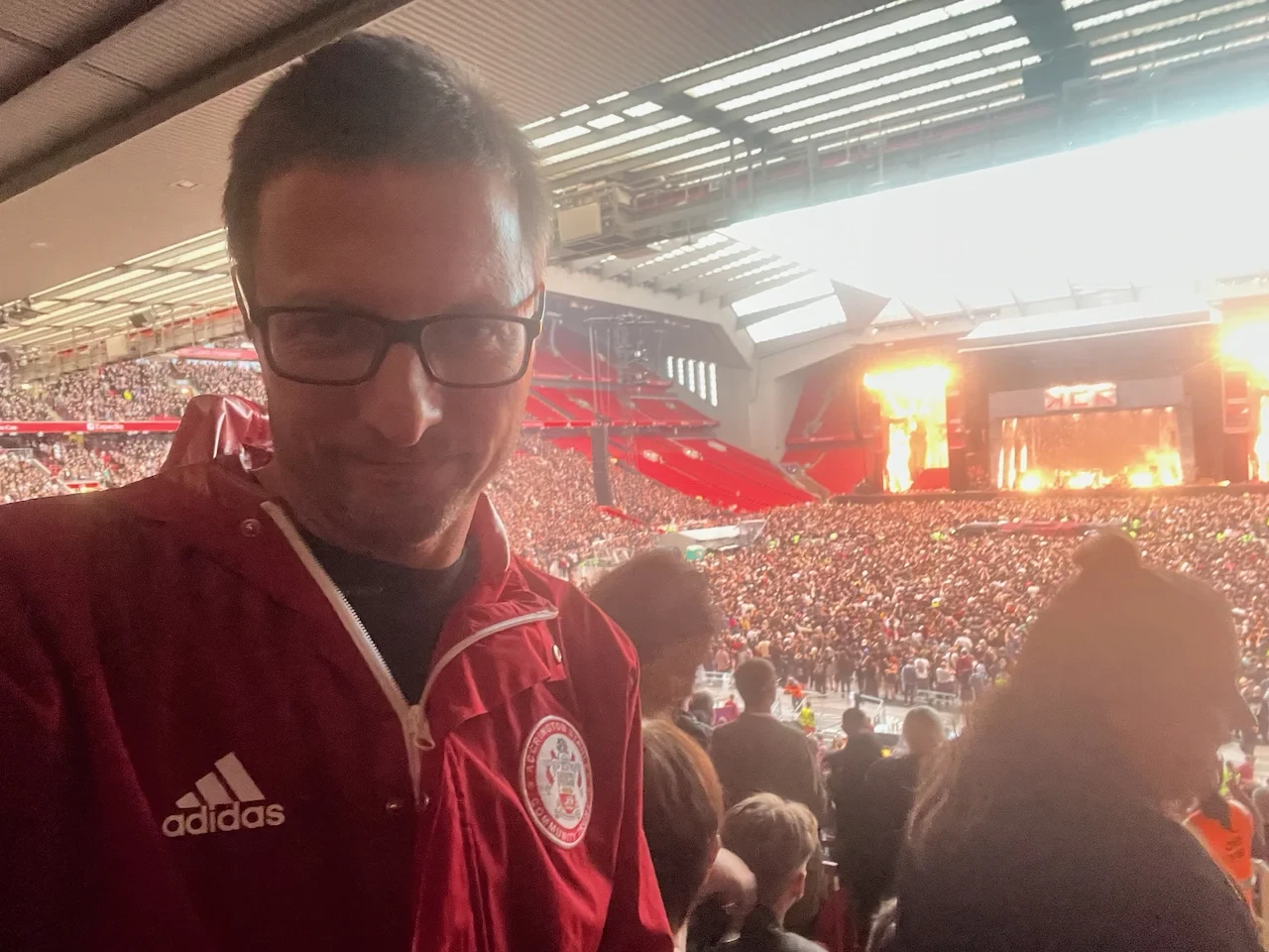 Me, wearing a red Accrington Stanley tunic, with Anfield beyond in concert configuration, with My Chemical Romance on stage
